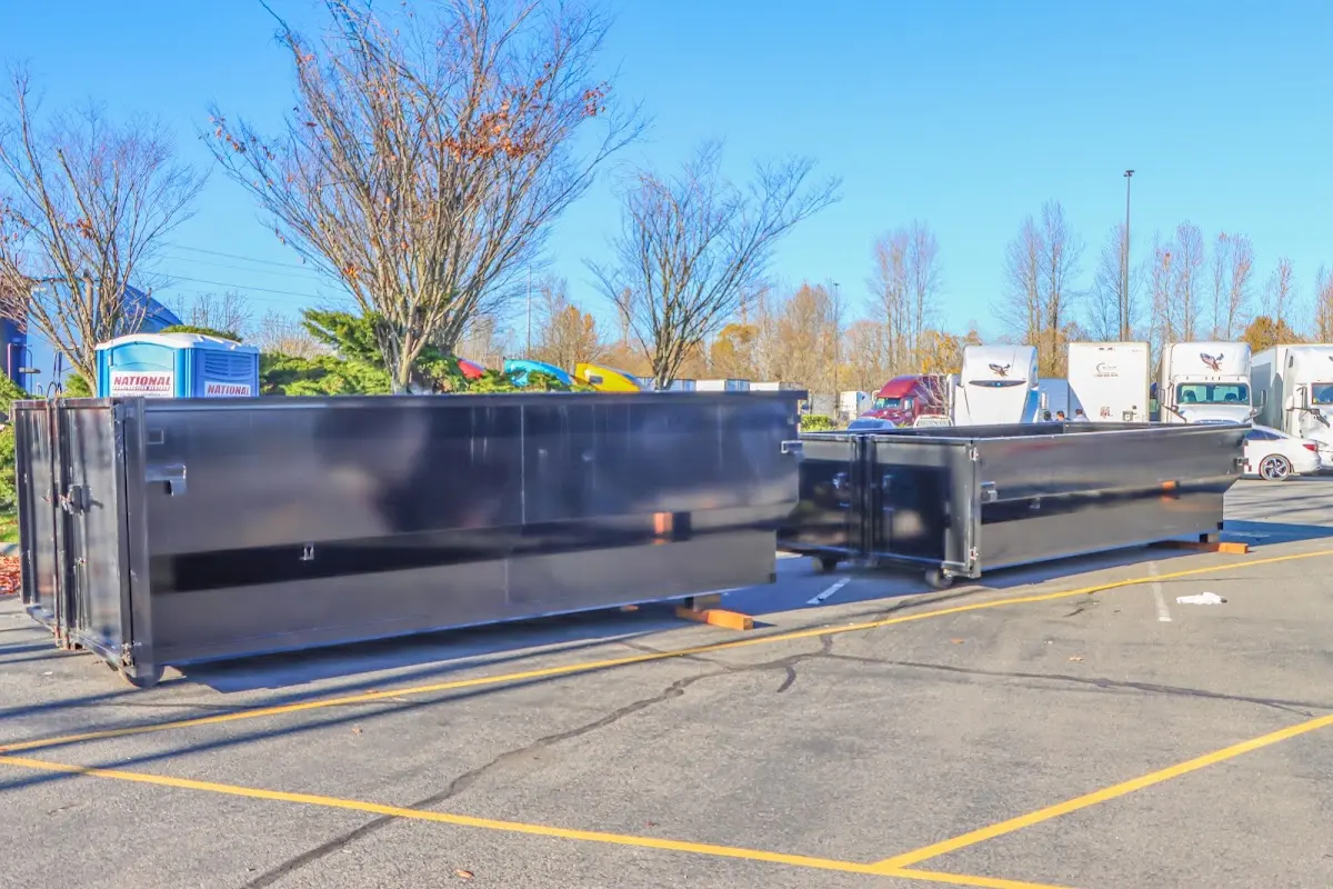 Professional dumpster rental service with roll-off container on residential driveway in Pingree Grove